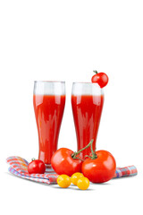 Two glasses with tomato juice and a small tomato on a bright background.