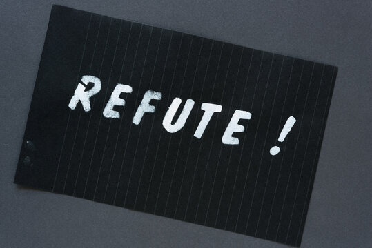 the word "refute!" in alpha/numeric plastic stencil letter type - hand painted in white acrylic paint - on black pad paper with faint lines - on dark gray paper