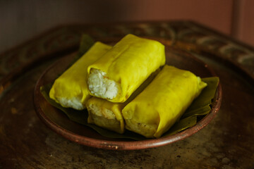 arem-arem is traditional food from java. is rice cake filled with spicy chicken, wrapped in banana leaf and steamed. It is an Indonesian traditional savory snack and street food.