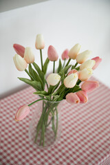 home interior decoration a bouquet of tulips in a vase on table.