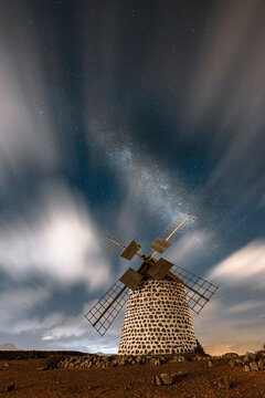 Long exposure image of clouds in the night sky over the old windmill, La Oliva, Fuerteventura, Canary Islands, Spain