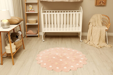 Baby room interior with modern furniture and soft rug