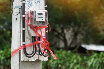 Concept : unsafe electricity fixing. Red plastic rope is used to tie old and broken watthour meter...