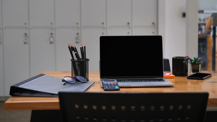 Fototapeta premium Mock up with laptop placed on wooden table, Office desk concept.