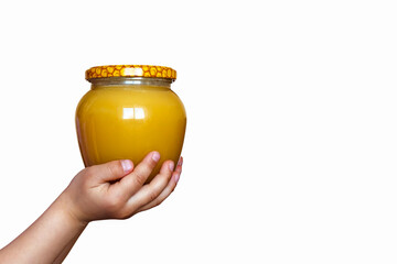 Honey jar in children's hands on a white background