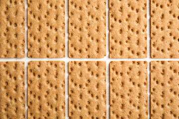 Fresh rye crispbreads on white wooden table, flat lay