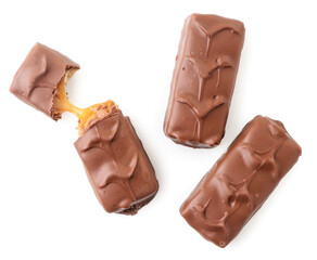 Chocolate bar with nougat and caramel, whole and broken on a white background, isolated. Top view