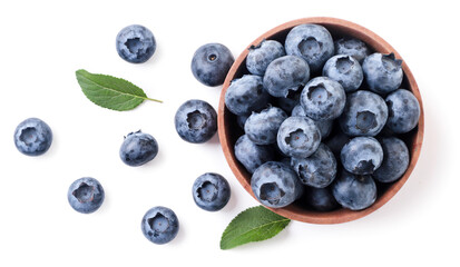 Blueberries with green leaves in a wooden plate on a white background, isolated. Top view