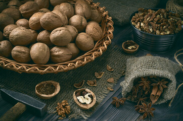 Wicker dish with walnuts on a dark wooden table.