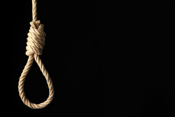 Rope noose with knot on black background, space for text
