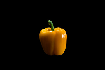 yellow pepper on black background