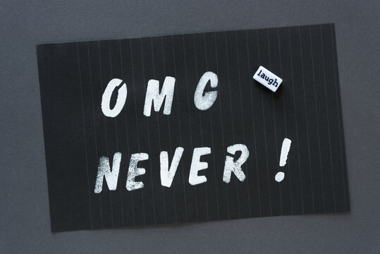 the words "OMG never!" in alpha/numeric plastic stencil letter type - hand painted in white acrylic paint - on black pad paper with faint lines and the word bead "laugh" - on dark gray paper