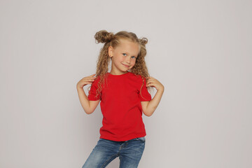 a beautiful blonde girl with ponytails in a red T-shirt shows various emotions sadness ,surprise,...