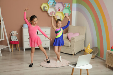 Cute little girls taking online dance class at home