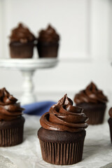 Delicious chocolate cupcake with cream on grey table. Space for text