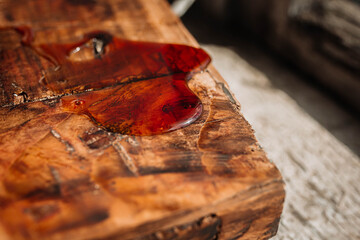 Wood treatment with epoxy varnish, surface restoration. Elm wood table with epoxy resin. The table top is made of wood. Woodworking, joinery, furniture manufacturing.