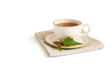 Chaga tea. Cup with a chaga drink on a napkin isolated on a white background. Healthy drink with birch mushroom. Copy space.