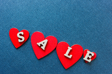 sale sign with red hearts on a blue background