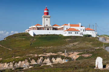 Fototapeta na wymiar Portugal. Cabo da Roca and the lighthouse over Atlantic Ocean, the most westerly point of the European mainland. Aerial view. Concept for travel in Portugal and most beautiful places in Portugal.