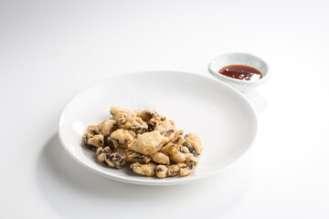 Fried breaded mushrooms with dip sauce isolated on white background