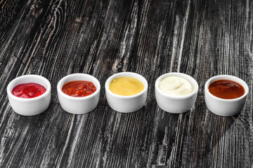 assorted sauces on a dark wooden background. High quality photo