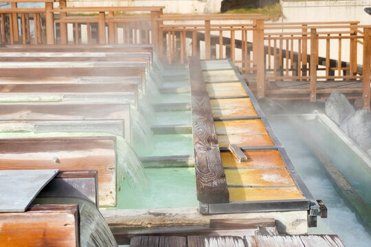 Yubatake hot spring steam covered wooden track boxes with mineral water in winter,Kusatsu ,Gunma Japan. © P. Lesley