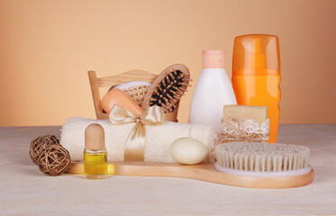 Fototapeta na wymiar SPA set. Body brush, scented soap, massage oil, candle and skin care products