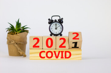 Covid-19 pandemic in 2022 symbol. Turned a wooden cube and changed words 'covid 2021' to 'covid...