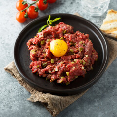 Traditional beef steak tartare with egg yolk