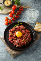 Traditional beef steak tartare with egg yolk