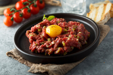 Traditional beef steak tartare with egg yolk