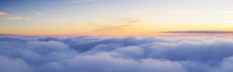 Panoramic view above clouds with beautiful sunset. - obrazy, fototapety, plakaty