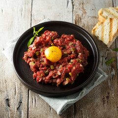 Traditional beef steak tartare with egg yolk