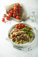 Couscous salad with grilled beef steak and herbs