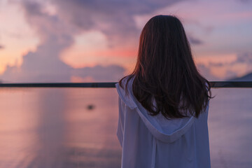 a woman looking at sunrise