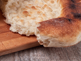 flatbread on a wooden table, fresh baked bread
