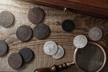 Numismatics. Old collectible coins on a wooden table.