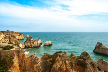 Fototapeta na wymiar A view of cliffs meeting turquoise water at the coastline of Atlantic Ocean, Partimao, Portugal