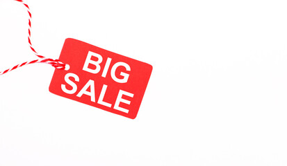 The inscription BIG SALE on a red price tag on a light background. Advertising concept. Copy space