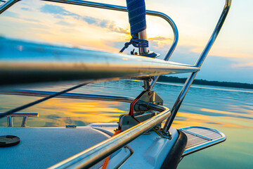 Sailing boat on the sea, a man on a beautiful golden sunset