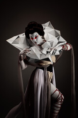 Geisha wearing origami dress and necklace in the twilight