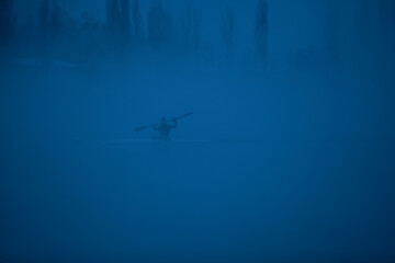rowing on the river in the fog - 446660856
