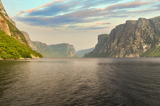 Admiring the beautiful view from the tour boat at the fjords of the Western brook pond in Gros Morne National Park, Newfoundland and Labrador, Canada