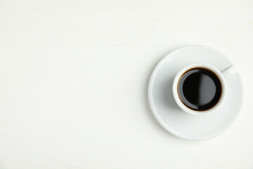 Cup of hot aromatic espresso on white background, top view