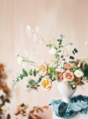 portrait shot of asymmetrical floral arrangement with blue linen