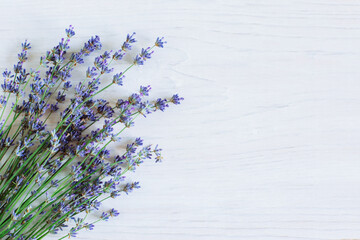 Beautiful lavender flowers on a white wooden background.