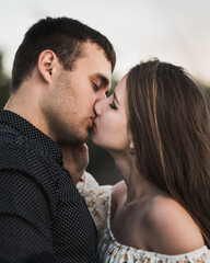 Close up sensual portrait of young kissing couple in love
