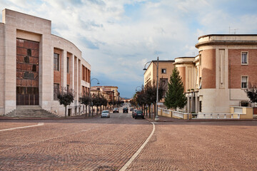 Predappio, Emilia-Romagna, Italy: the main avenue of the town with the old buildings in rationalist architecture built in the fascist period - obrazy, fototapety, plakaty