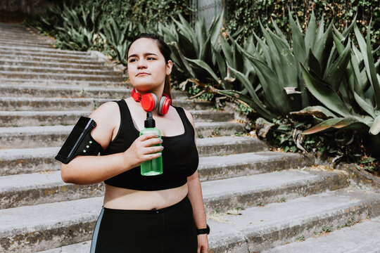 plus size young latin woman running in park in Mexico