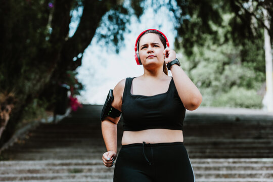 plus size young latin woman running  in park in Mexico